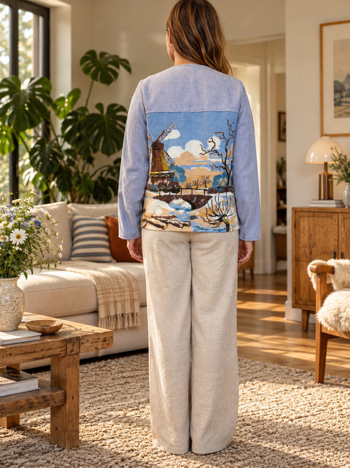 Back view of blue tapestry jacket with windmill scene