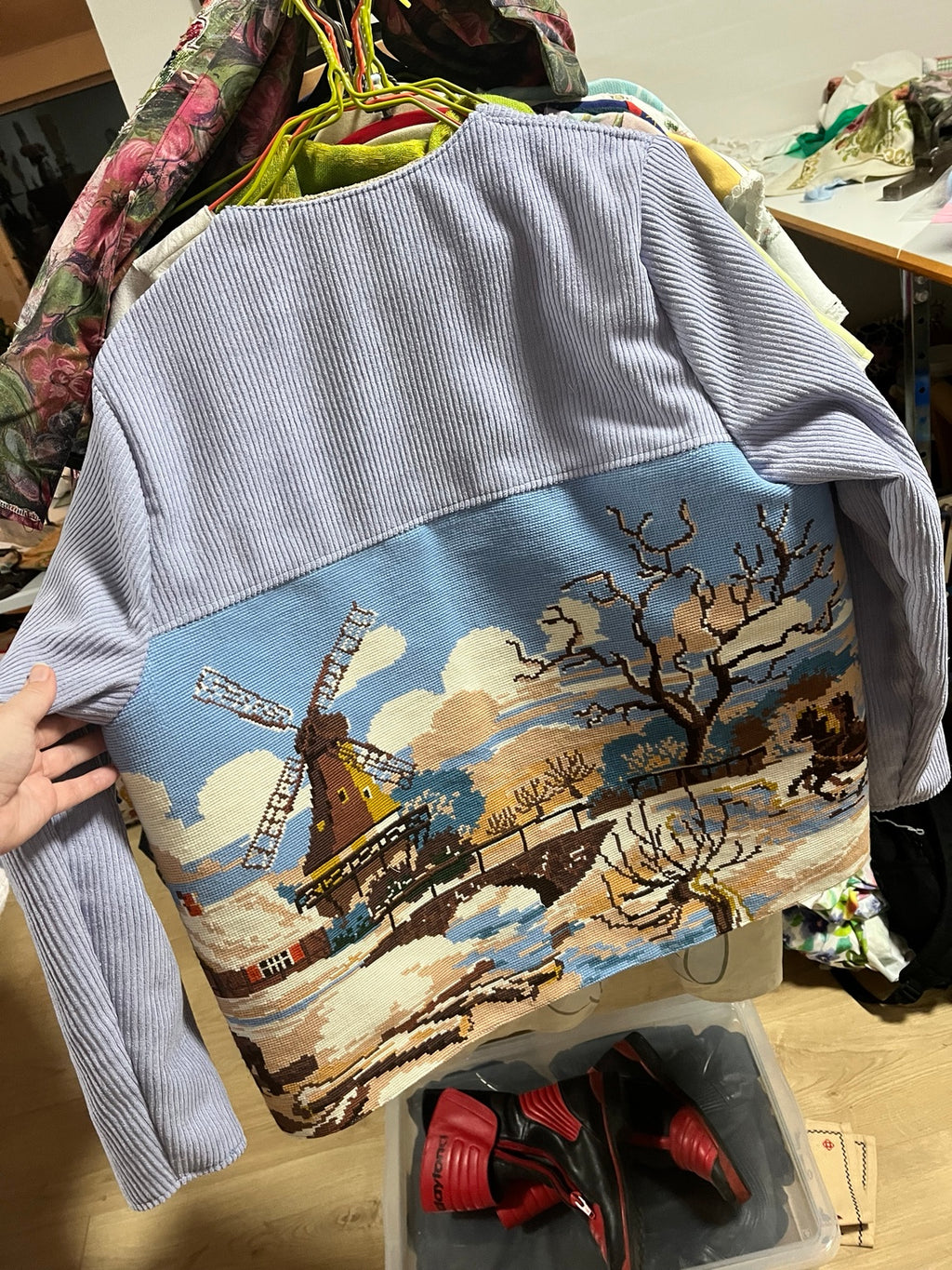 Back of winter-scene tapestry jacket on hanger