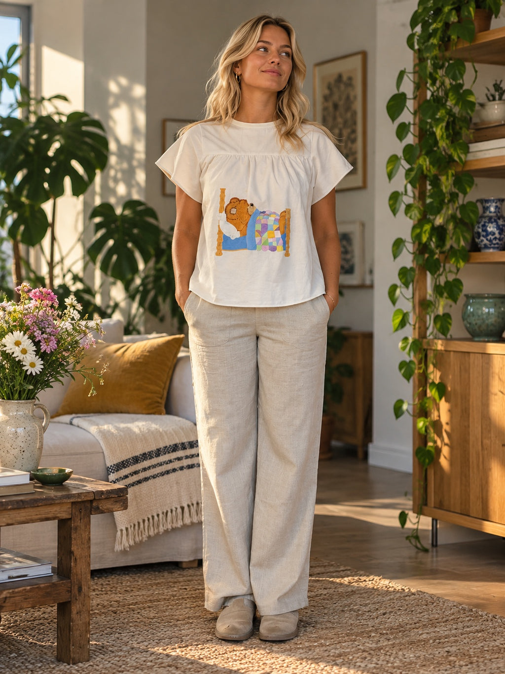 Front view of white top with sleeping teddy-bear appliqué