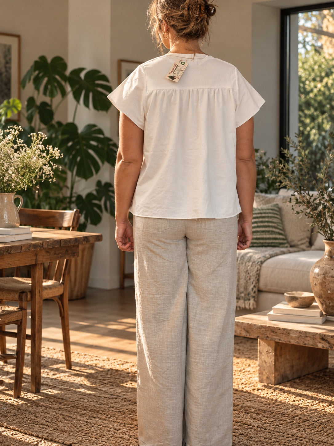 Back view of white gathered-yoke top
